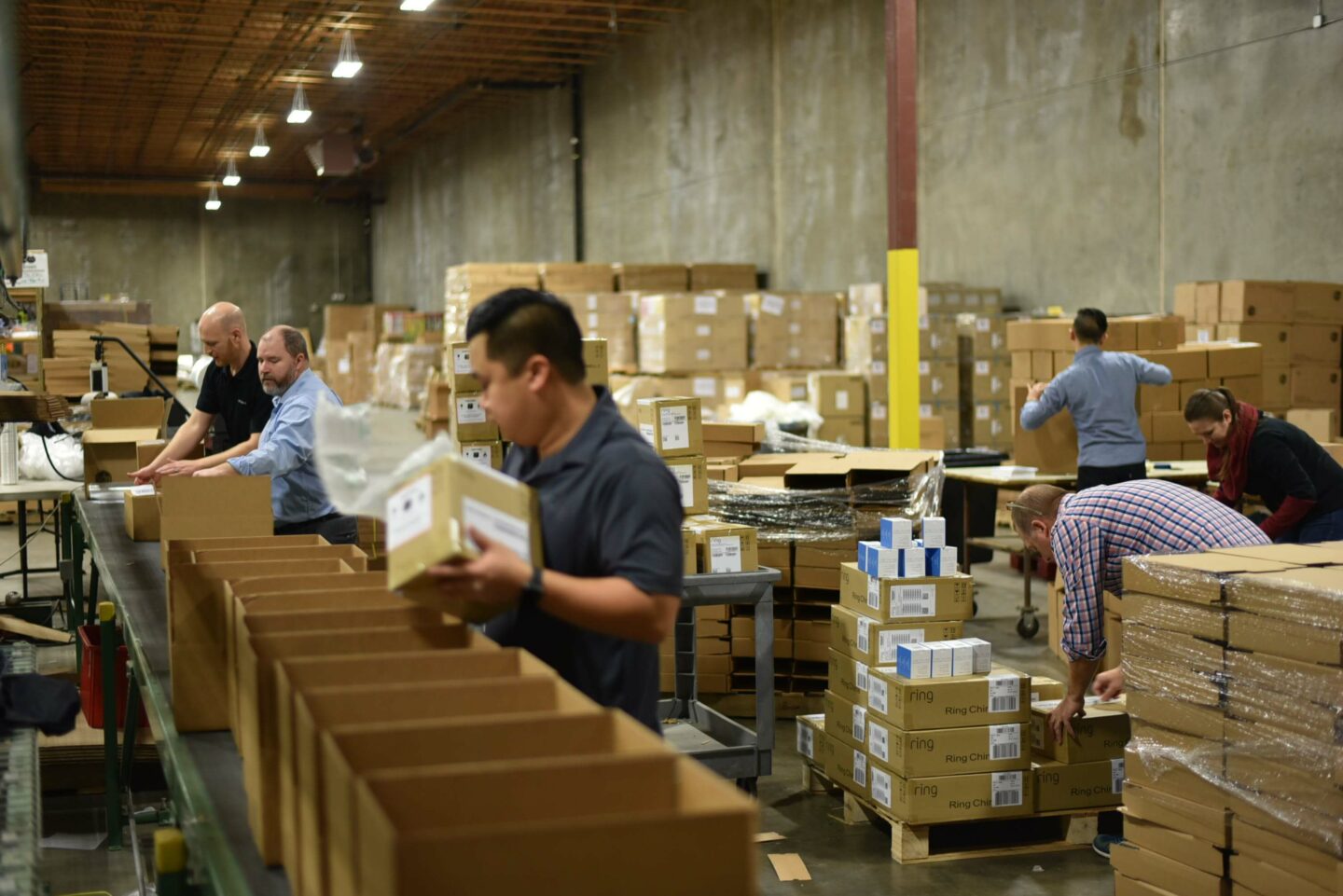 People and boxes in warehouse