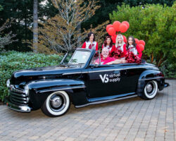 People sitting in old car with wearing Virtual Supply clothes